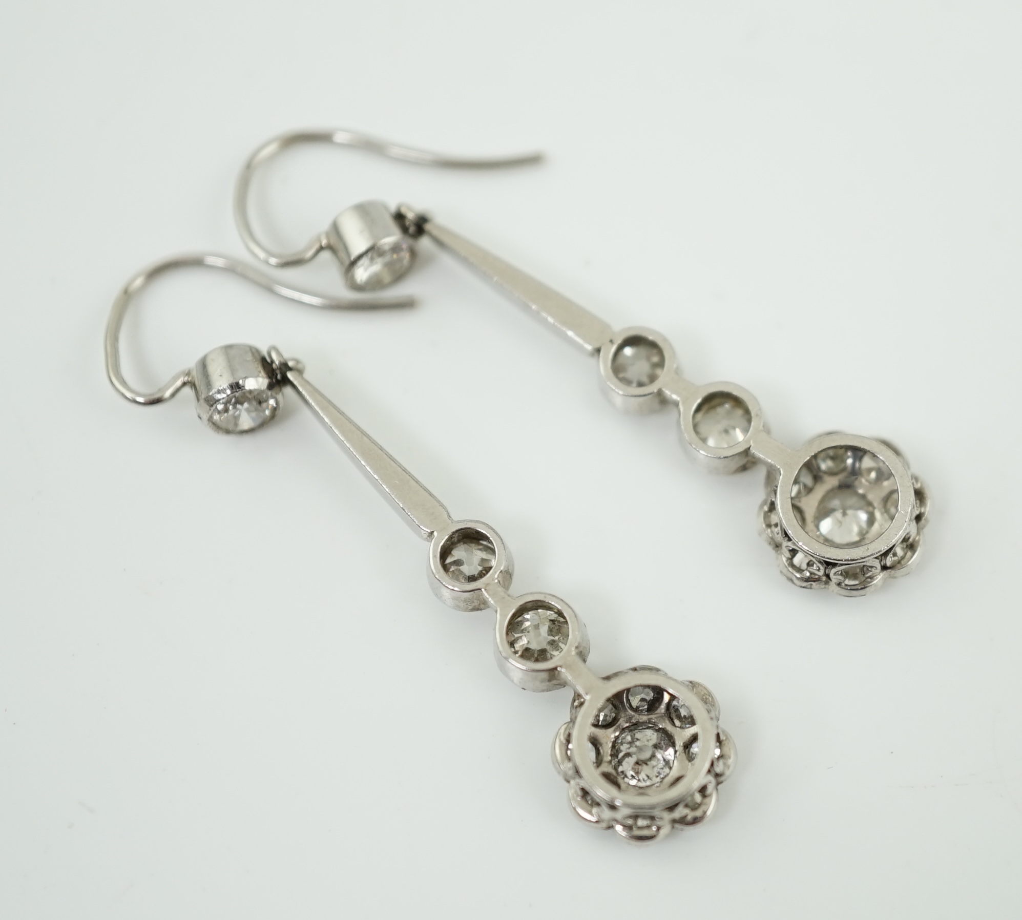 A pair of 1920's style platinum? and millegrain set diamond cluster drop earrings